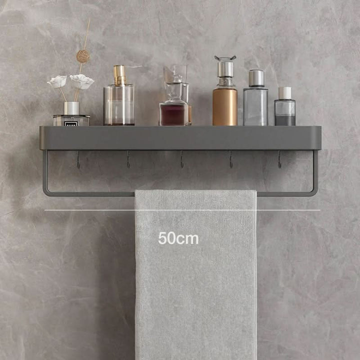 Wall-mounted bathroom shelf organizer & towel bar provides essential storage without drilling.