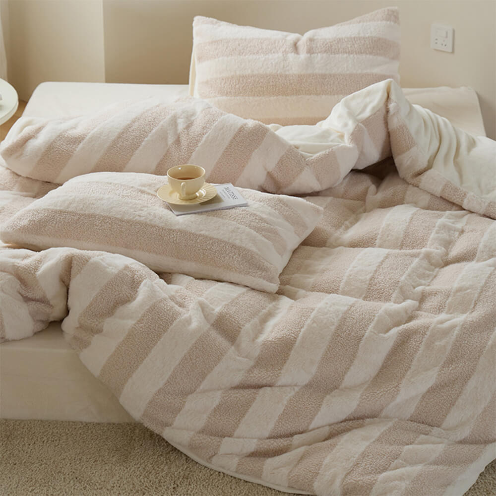 Velvet and sherpa striped sheet set, creating a warm and inviting bedroom ambiance