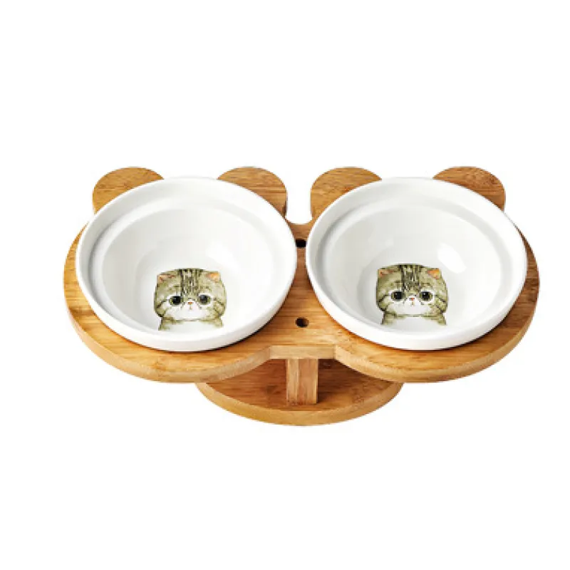 Raised ceramic pet feeder with two white bowls and a stylish bamboo stand for cats.