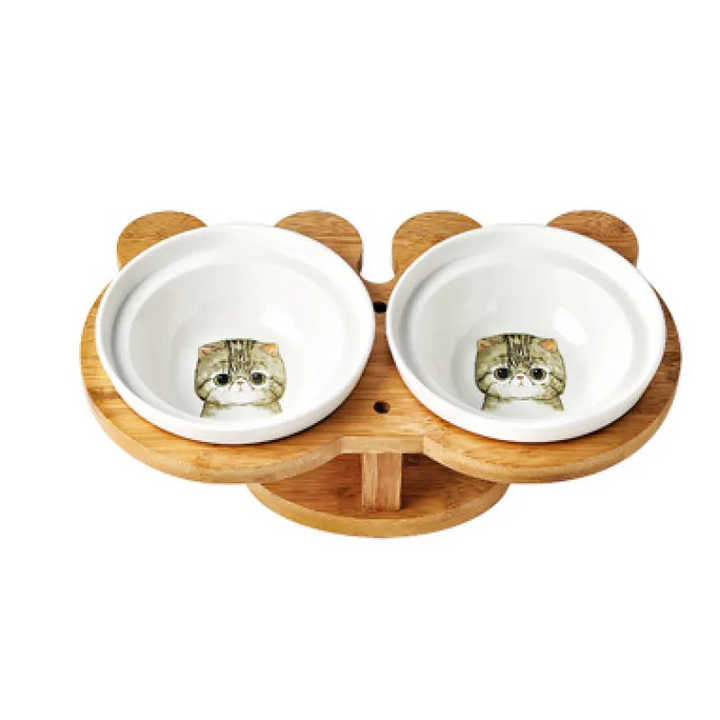 Raised ceramic pet feeder with two white bowls and a stylish bamboo stand for cats.