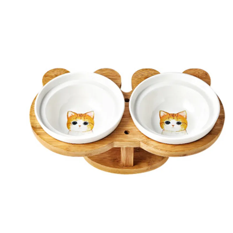 Two white ceramic cat bowls securely seated in a sturdy, elevated bamboo feeding station.