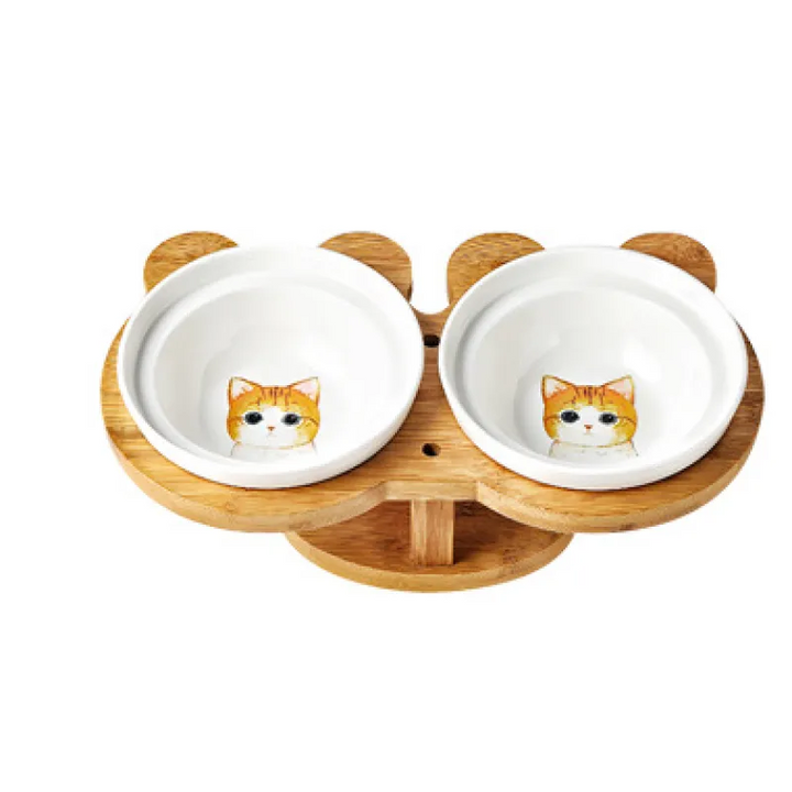 Two white ceramic cat bowls securely seated in a sturdy, elevated bamboo feeding station.