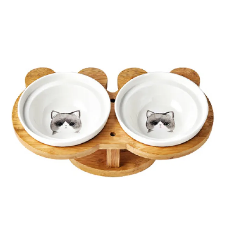 Modern pet supplies: double white ceramic cat bowls with an elevated, anti-slip bamboo stand.