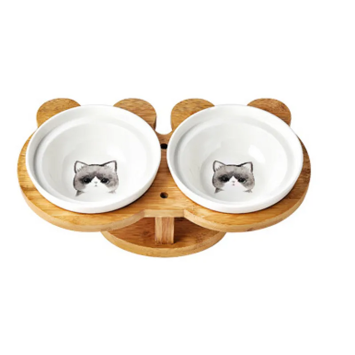 Modern pet supplies: double white ceramic cat bowls with an elevated, anti-slip bamboo stand.