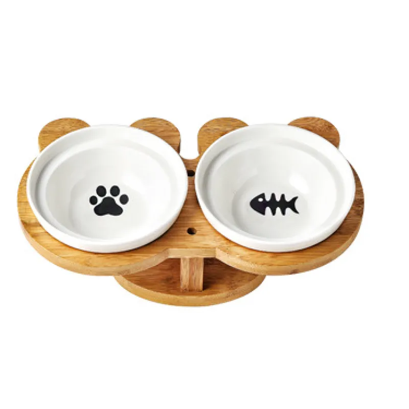 Ergonomic dual pet food and water bowls, white ceramic on an elevated bamboo stand for cats.