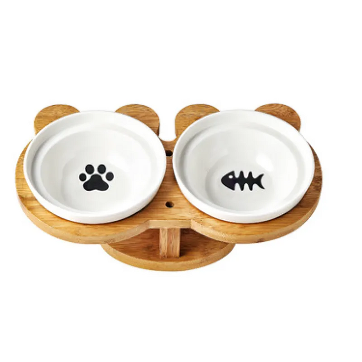 Ergonomic dual pet food and water bowls, white ceramic on an elevated bamboo stand for cats.