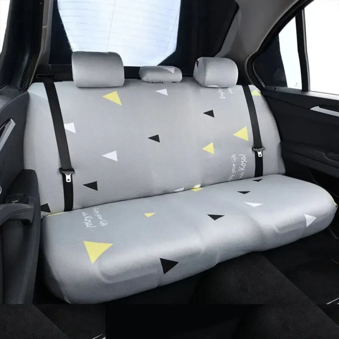 View of dog hammock car seat cover installed in a black car backseat, protecting upholstery from pet dander.