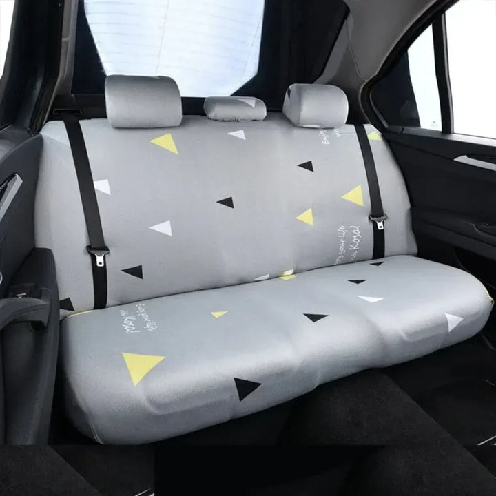 View of dog hammock car seat cover installed in a black car backseat, protecting upholstery from pet dander.