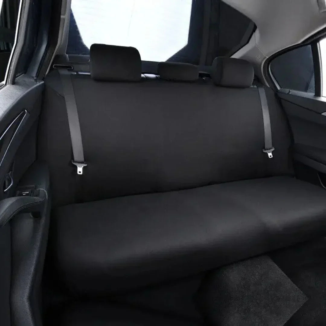 Close-up of waterproof fabric on a black dog car backseat hammock cover, highlighting durability for pets.