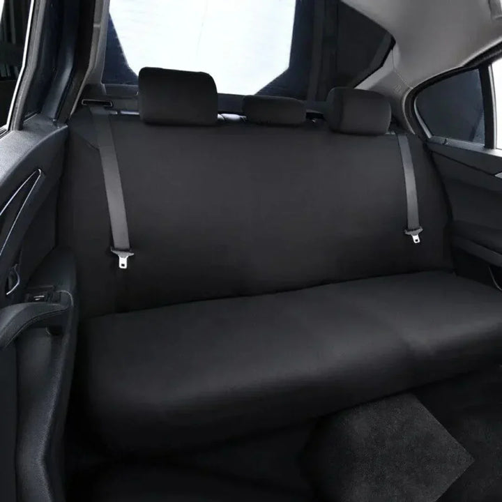 Close-up of waterproof fabric on a black dog car backseat hammock cover, highlighting durability for pets.