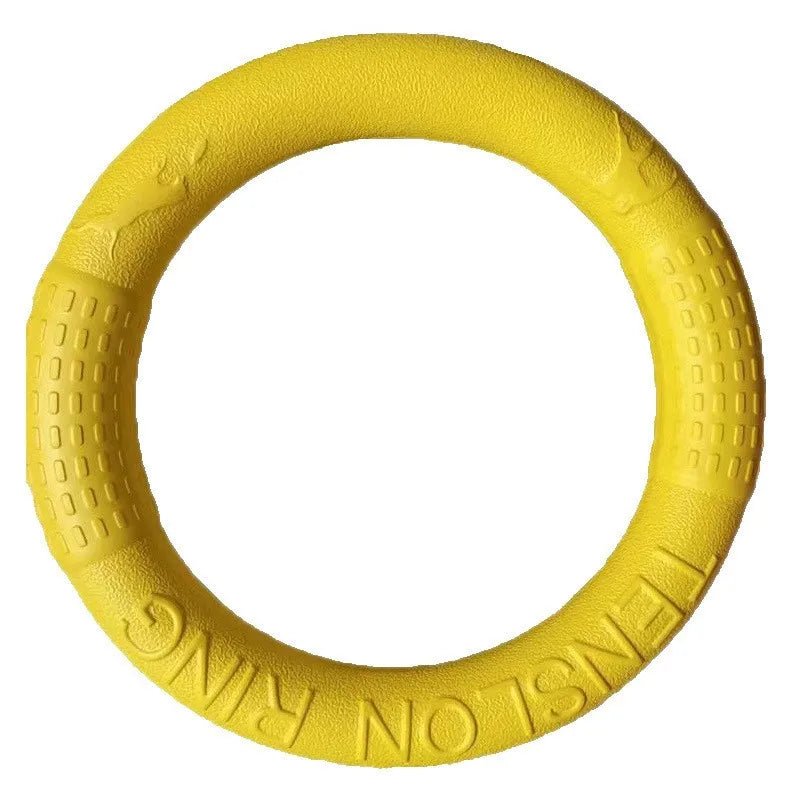 Dog owner throwing an orange EVA fetch toy ring for a dog, demonstrating its use in outdoor play.