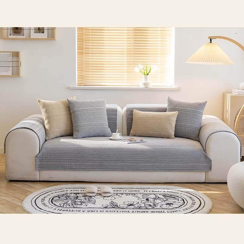 Lifestyle image of a family relaxing on a sofa with linen anti-scratch couch cover