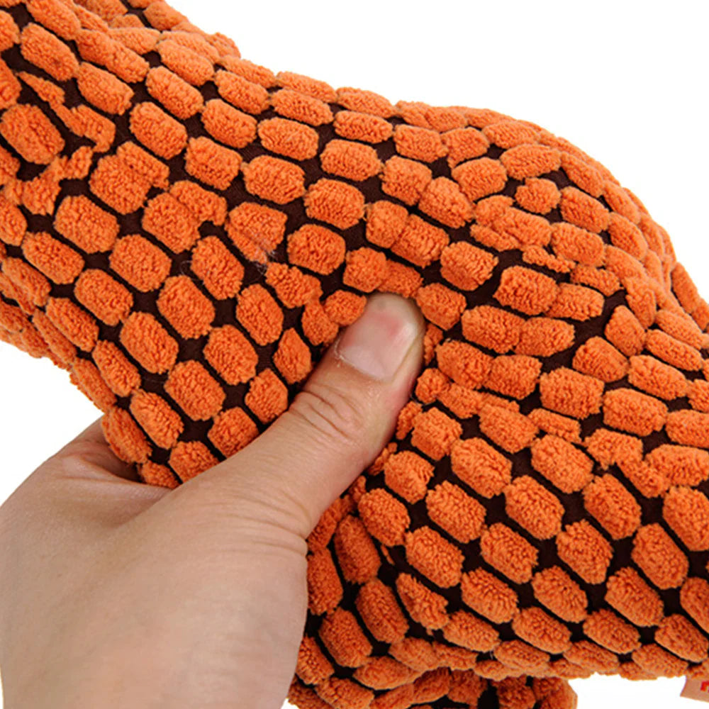 Close-up of a robust purple plush dog toy, showcasing its durable fabric