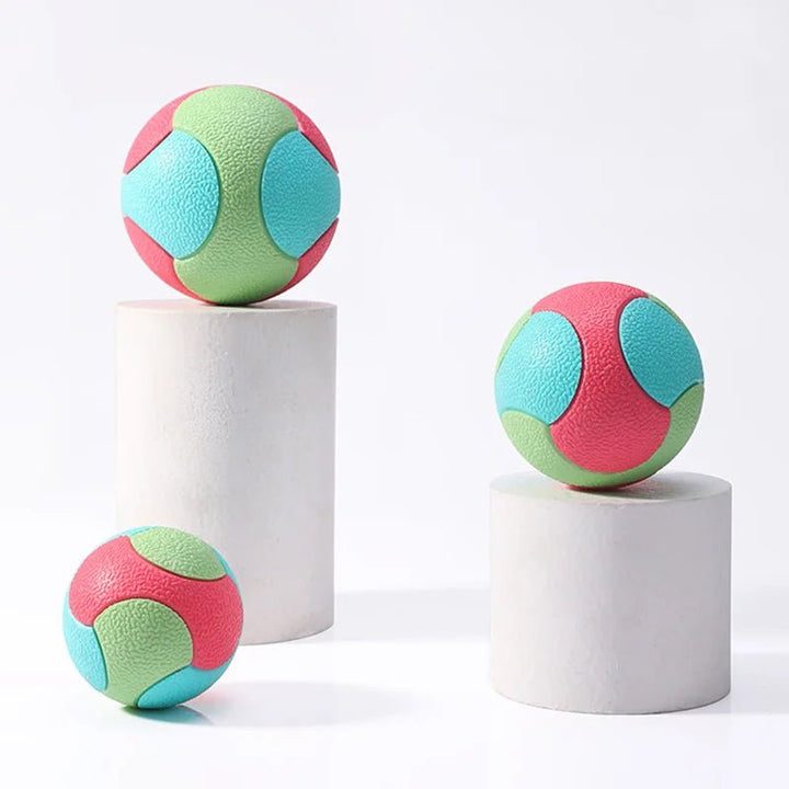 Close-up of a textured durable rubber chew ball dog toy, ideal for keeping pets entertained and teeth clean.