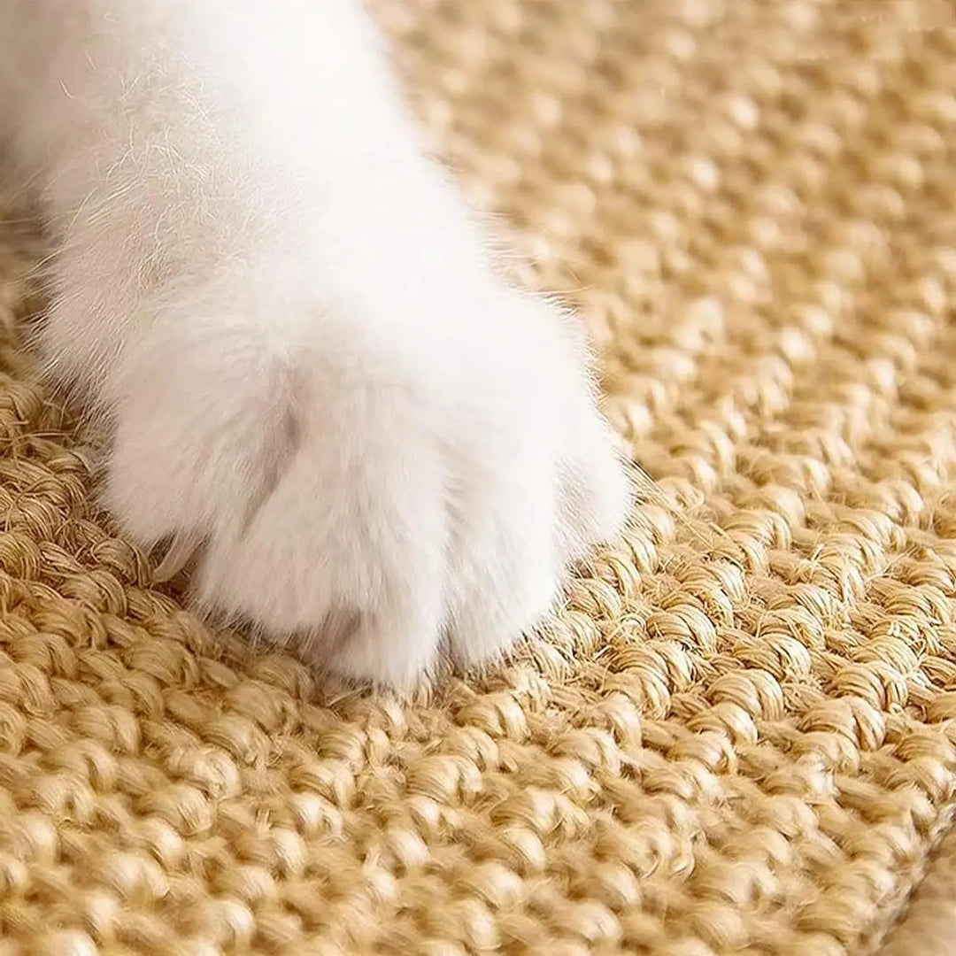 Sisal cat scratcher mat rolled out, pet furniture protector, an essential durable cat accessory.
