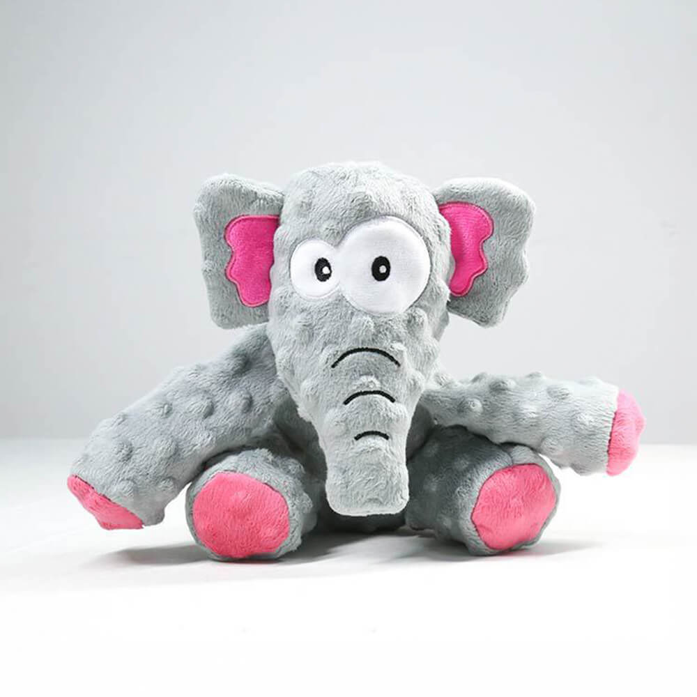 A dog happily chewing a tough squeaky elephant plush toy, demonstrating durability.