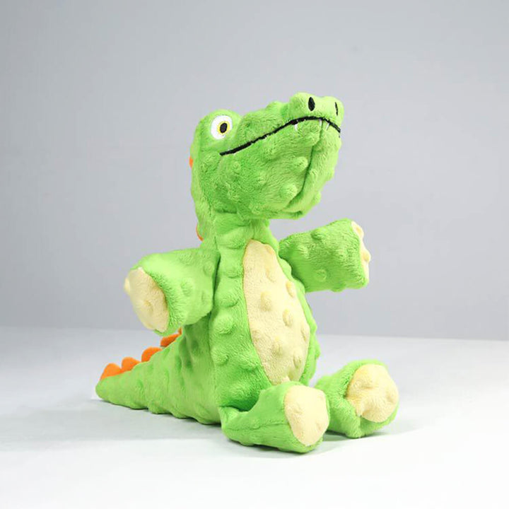 Pet accessories shot: elephant and crocodile durable squeaky chew toys on a pet mat.