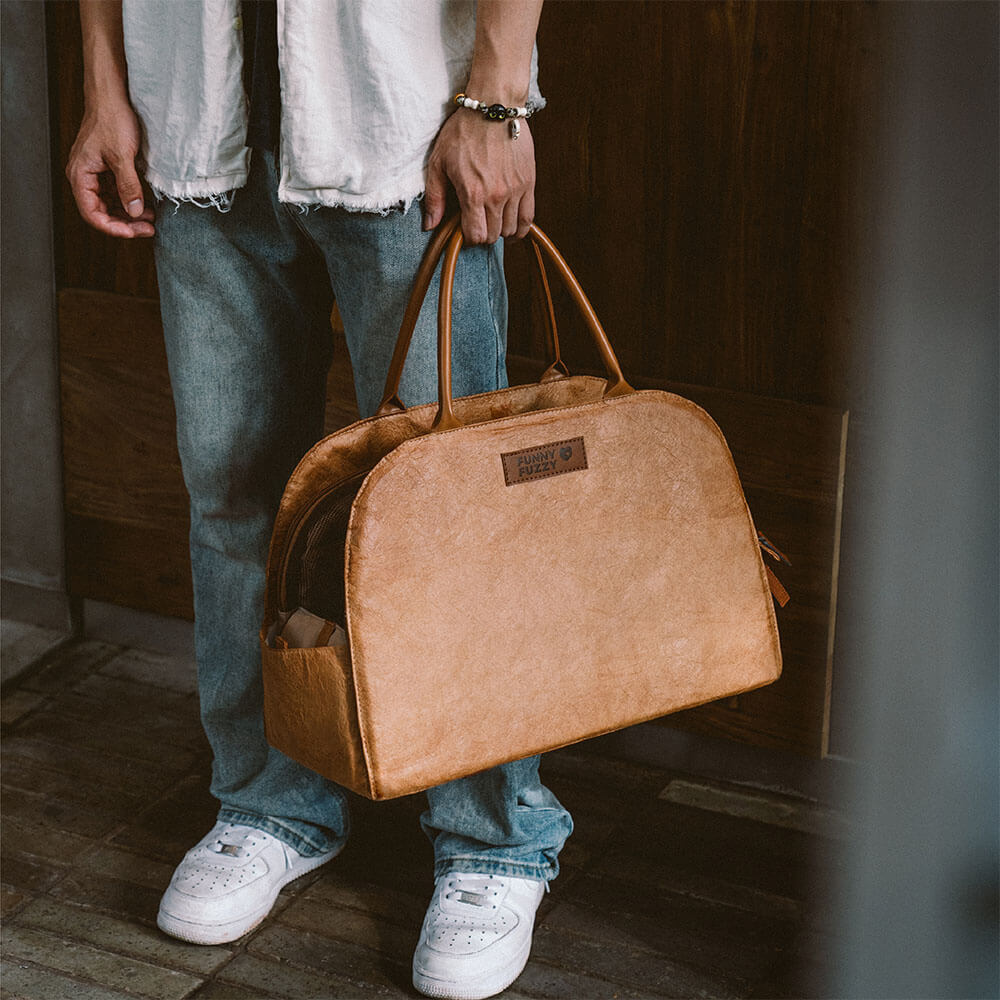 Modern pet travel carrier in a neutral tone, featuring expandable sections for pets