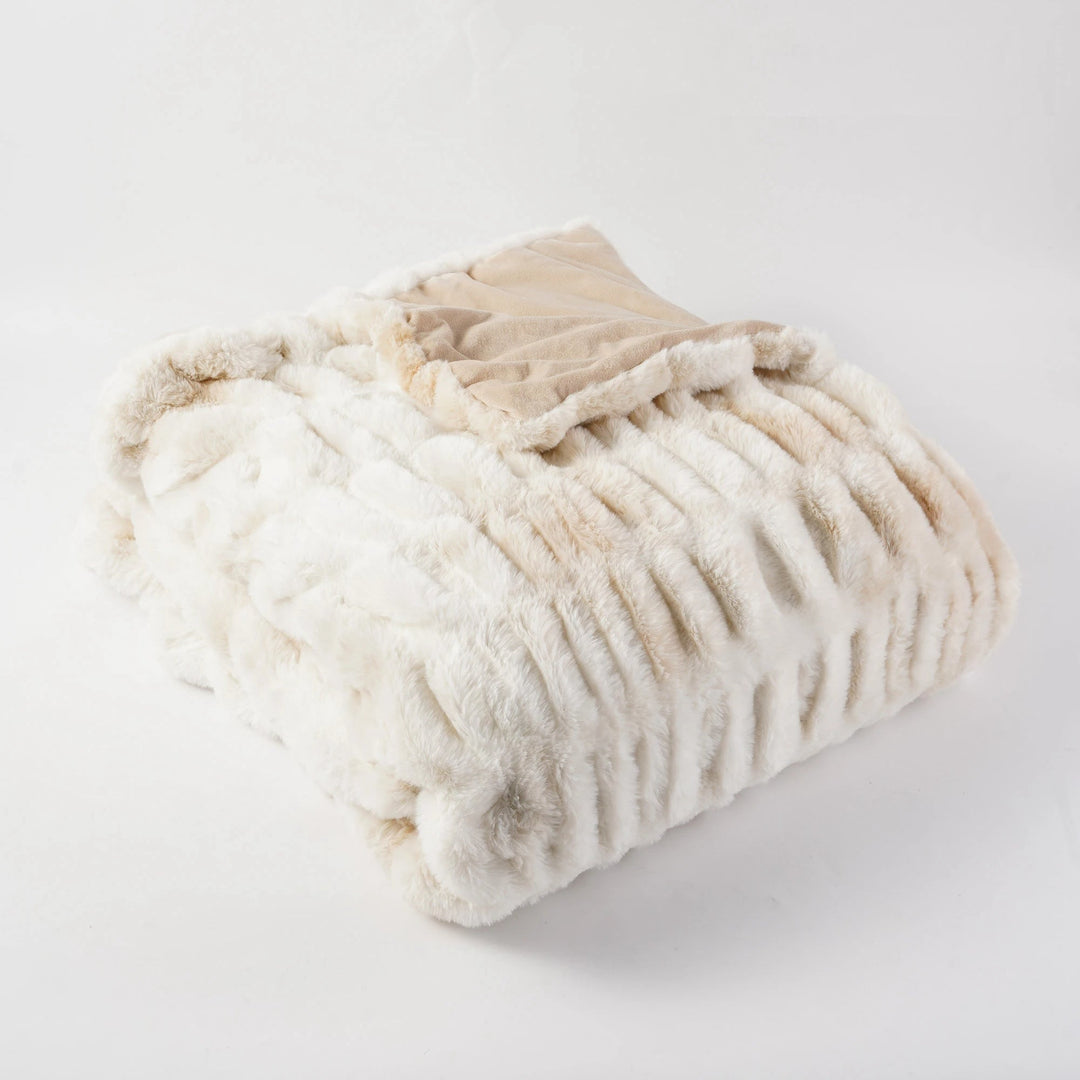 Warm faux fur throw, exquisitely soft and plush, ideal for cozy evenings.