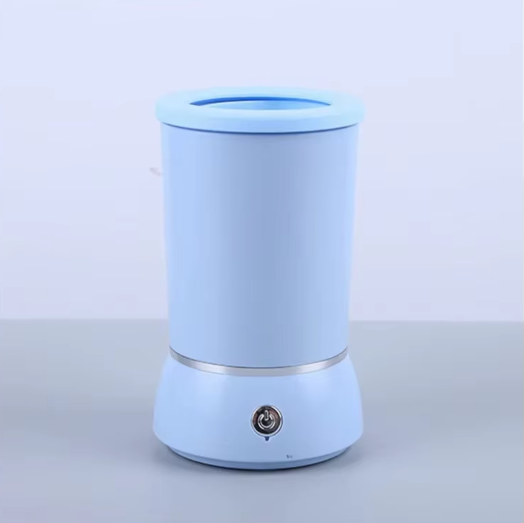 Hand holding electric dog paw cleaner demonstratingsize and portability for easy pet hygiene