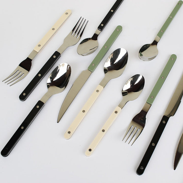 Stylish engraved stainless steel 24-piece flatware set. Durable dining cutlery, ideal for home kitchenware & decor.