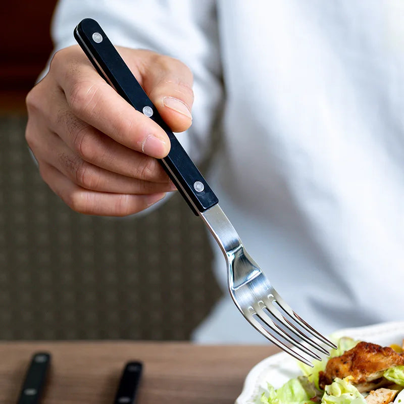 Complete 24-piece engraved stainless steel cutlery set for 6. High-quality dining tableware, enhances any meal.