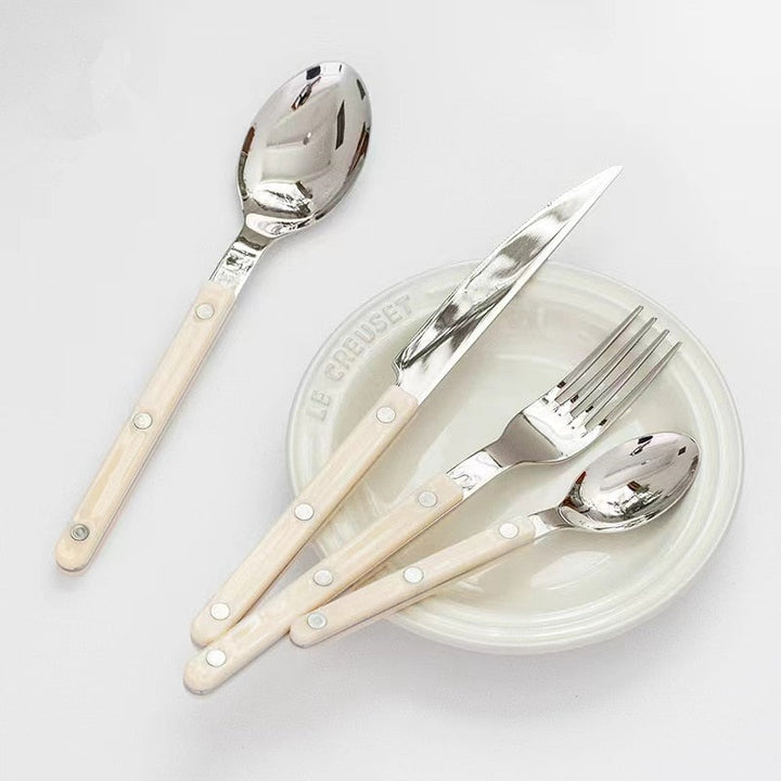 Sophisticated 24-piece engraved stainless steel cutlery set. Premium dining flatware, stylish kitchenware essential.