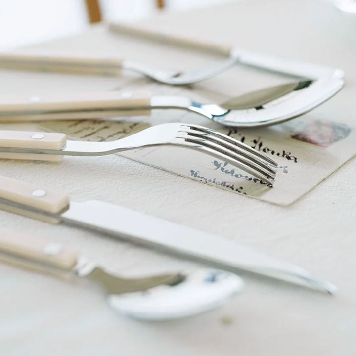 Modern 24-piece engraved stainless steel cutlery set. Elegant flatware for dining, durable and stylish tableware.
