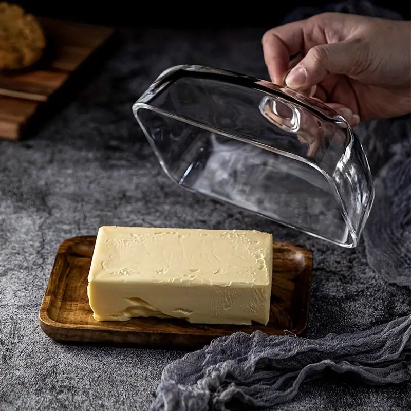 Modern acacia wood butter holder with a protective glass lid, ideal for fresh butter storage & serving.