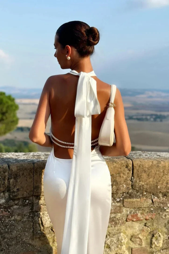 Women's glamorous backless halter maxi dress. Ideal sleeveless formal dress for special occasions.