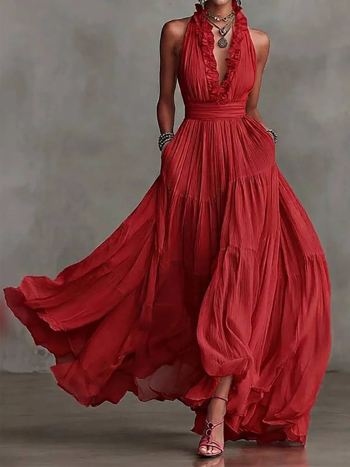 Women's elegant maxi dress featuring ruffle trim, backless style, pleated skirt for special events.