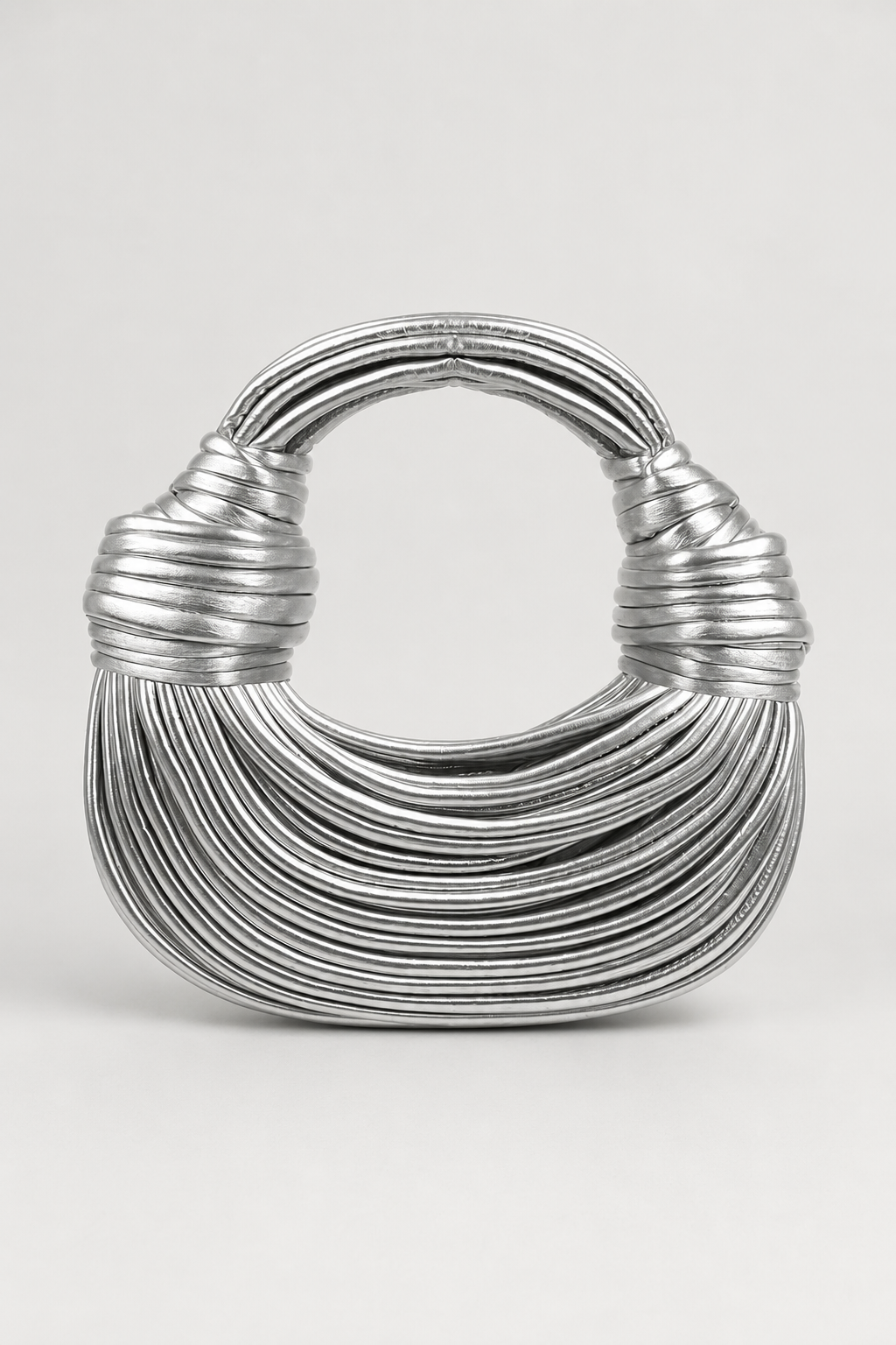 Black sculptural loop-handle crescent shoulder bag. Stylish women's modern everyday handbag, spacious & chic accessory.
