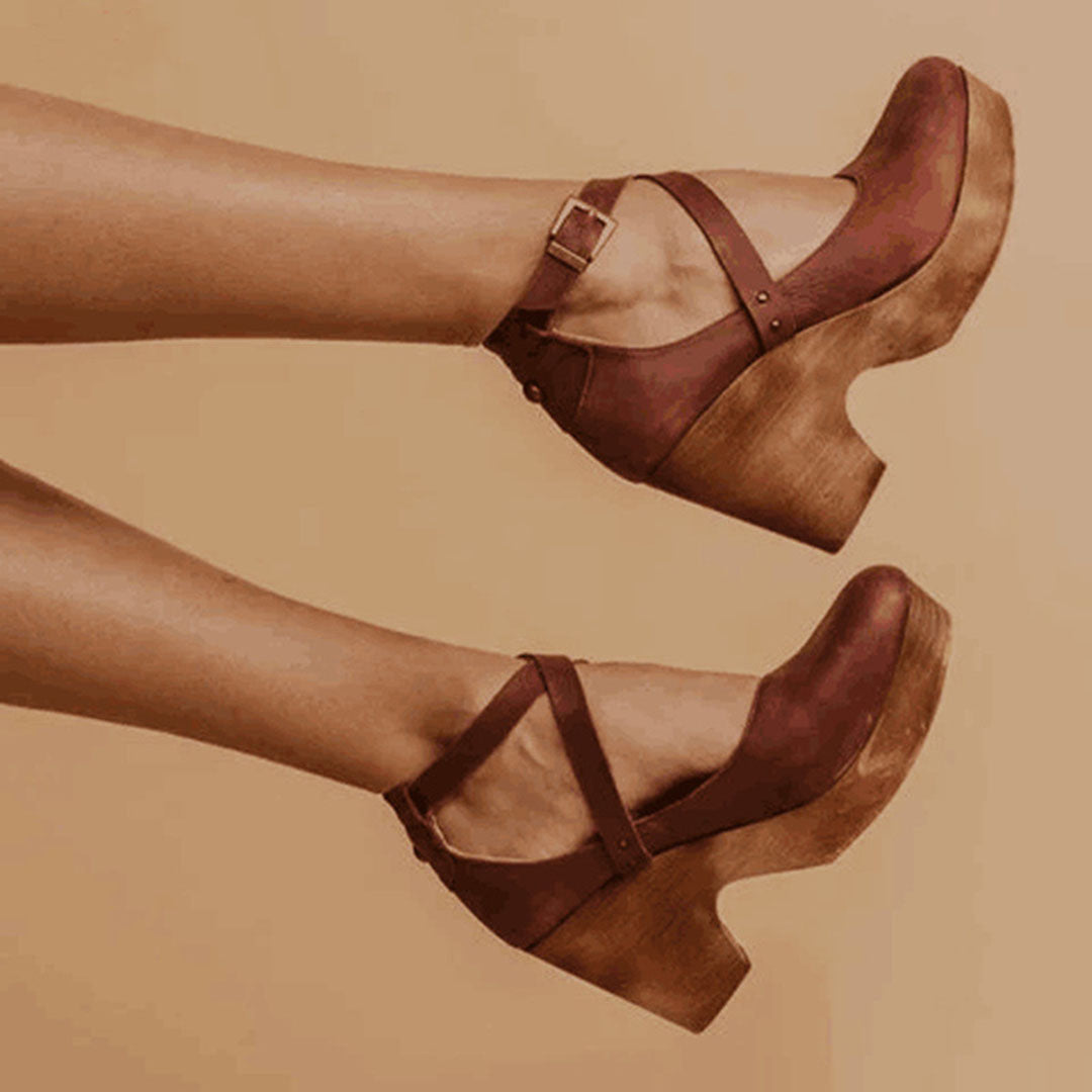 Stylish women's brown wedge heels with closed toe, comfortable & elegant footwear for versatile dress shoe occasions.