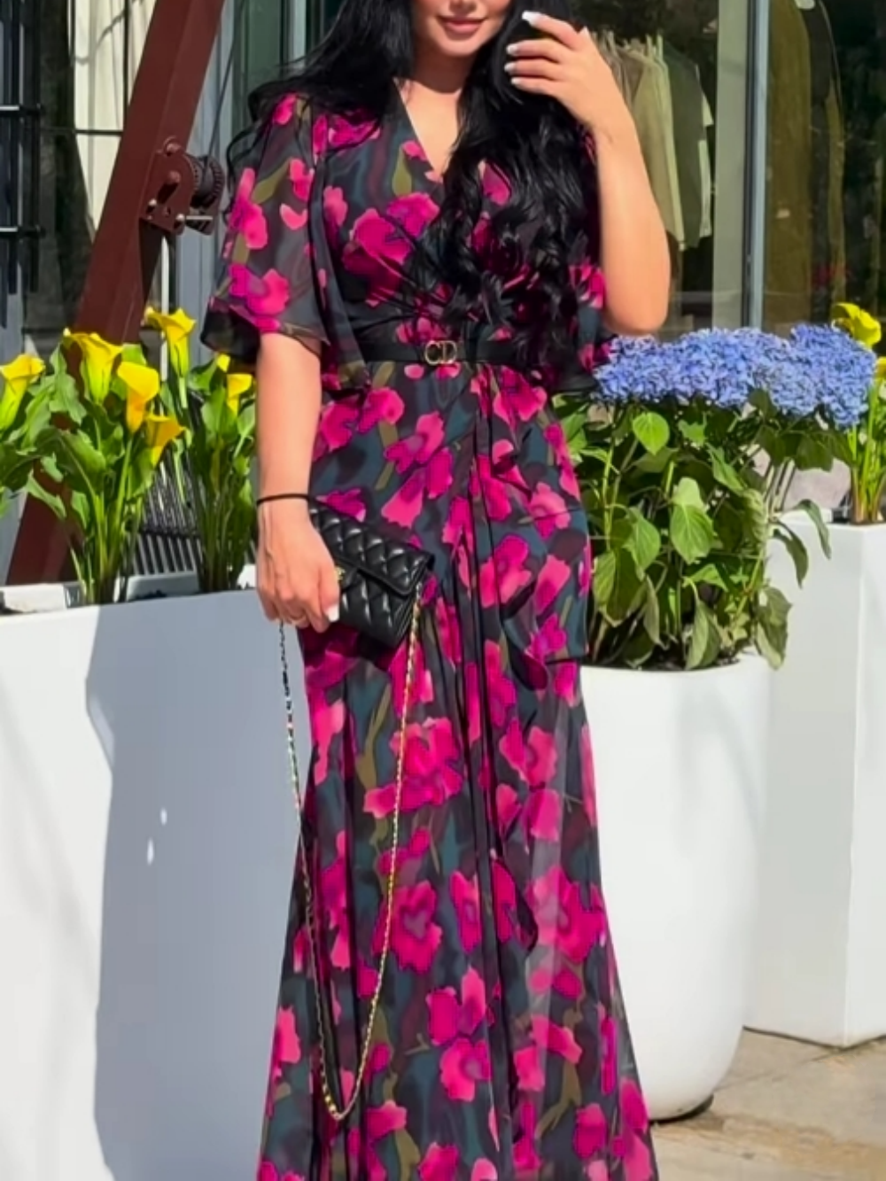 Elegant black floral print maxi dress for women, featuring a flattering V-neck and stylish trumpet sleeves.