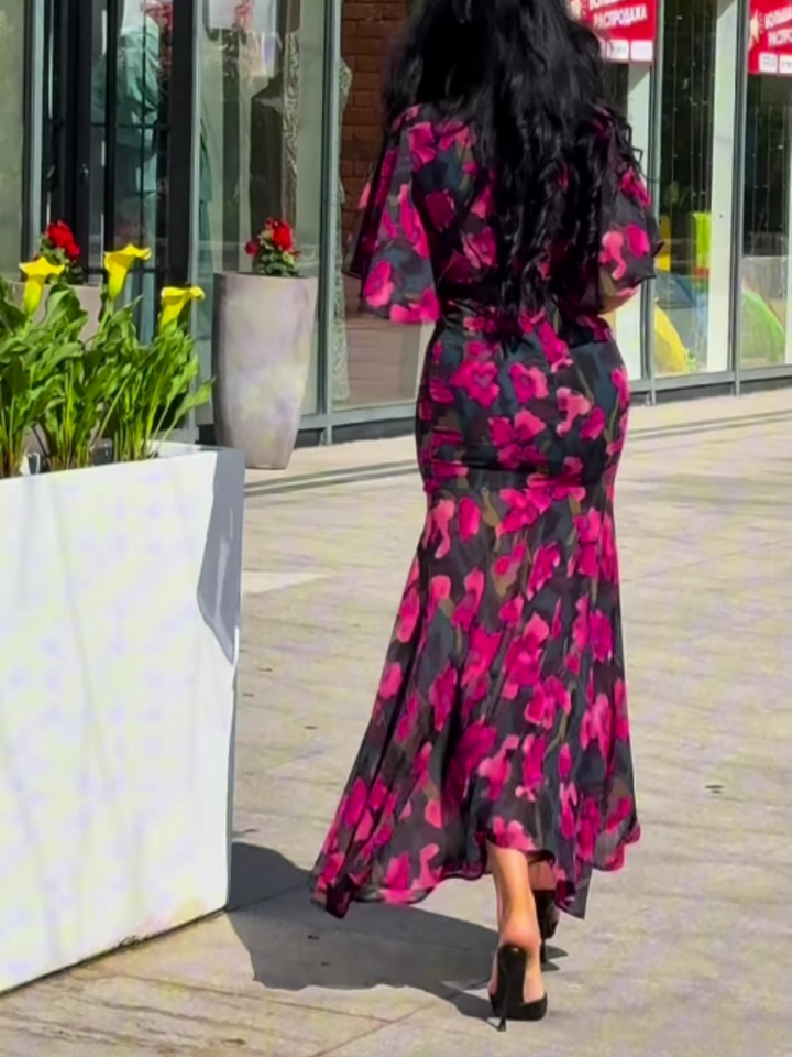 Women's effortless black floral maxi dress, belted for a flattering fit, with elegant V-neck and trumpet sleeves.