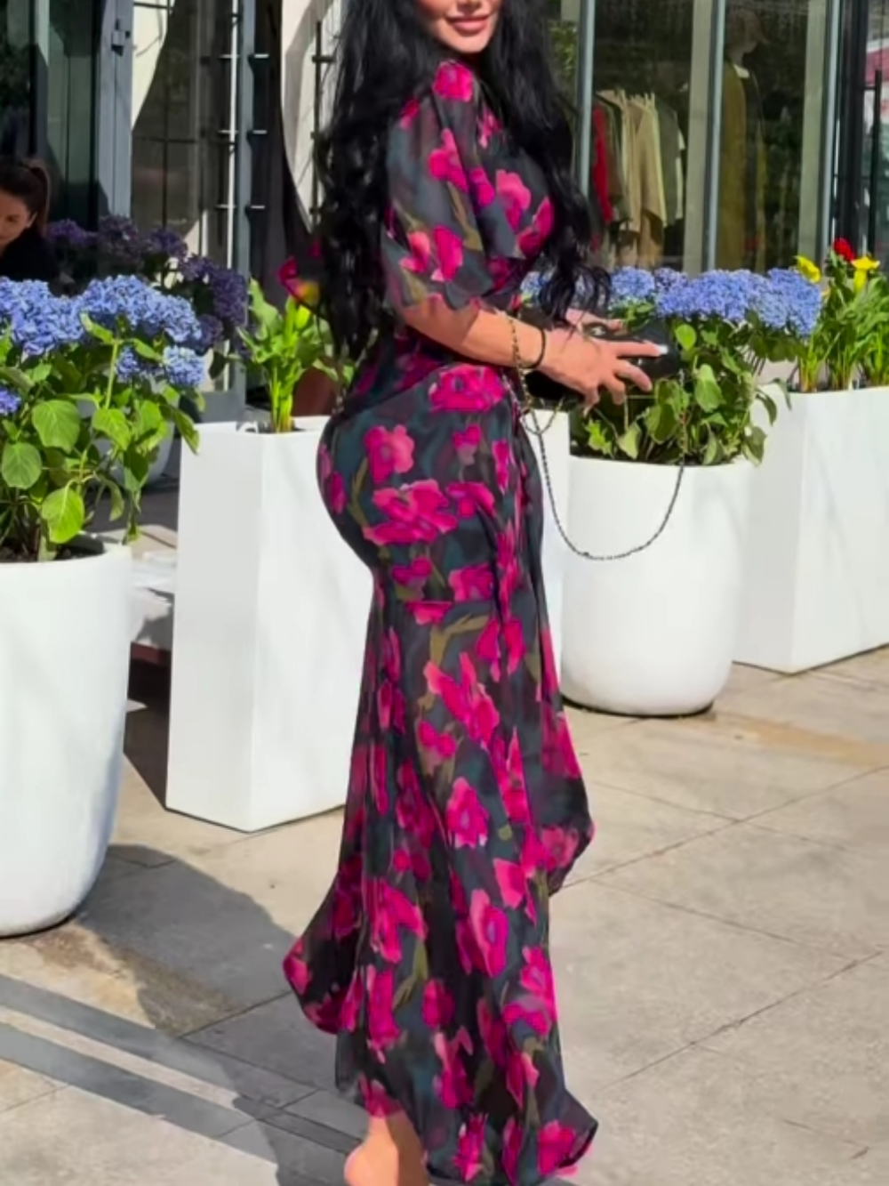 Stylish women's black floral print maxi dress with flowy trumpet sleeves and elegant V-neck for summer.