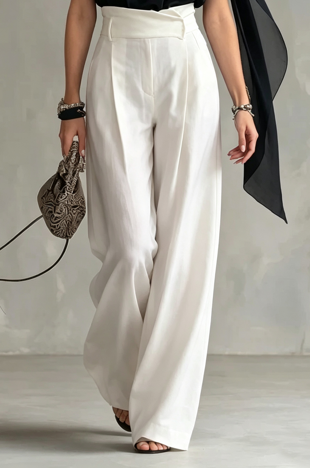 Chic black sleeveless halter top with unique draped cowl neck and elegant cape style, a dressy women's evening top.