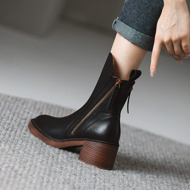 Side profile of luxurious black high-heel ankle boots, a comfortable & elegant choice for women's sophisticated footwear.
