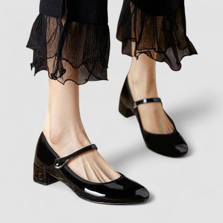 Elegant black patent Mary Jane shoes with a block heel and round toe for women.