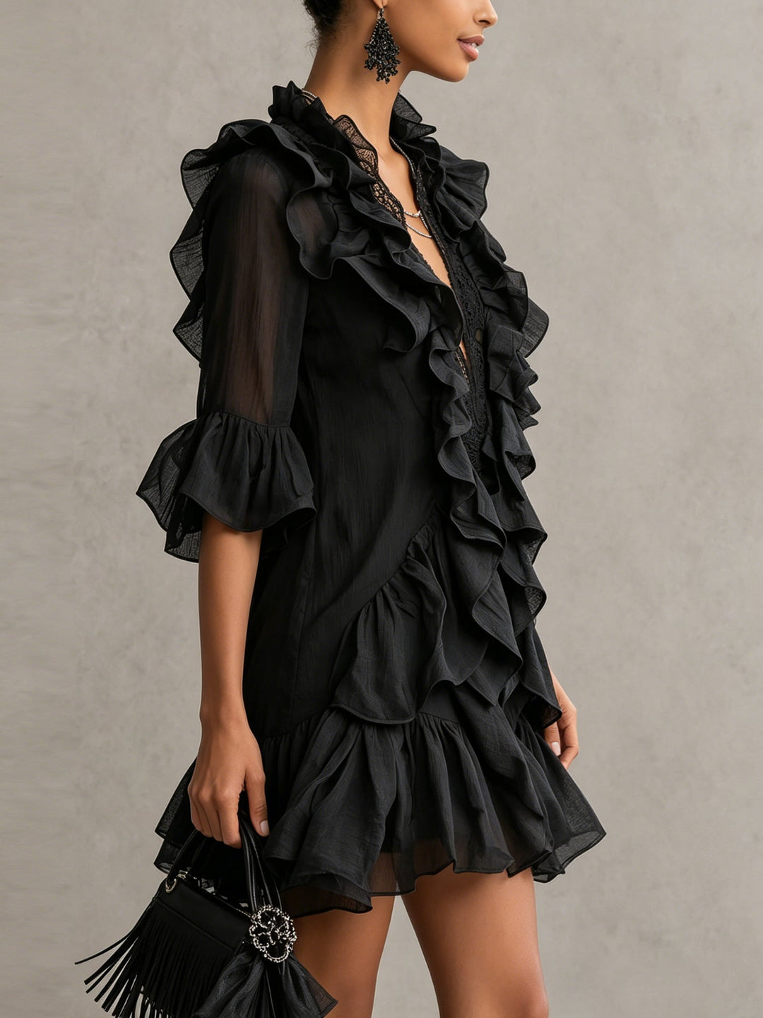 Women's black tiered ruffle mini dress featuring a stylish V-neck and delicate sheer sleeves, evening wear.