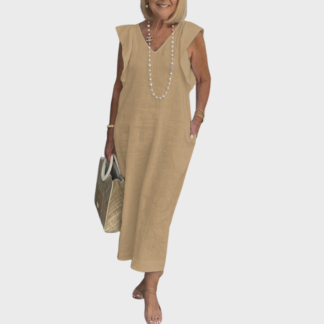 Versatile women's black maxi dress; ruffle shoulder, V-neck, sleeveless, and pockets. Ideal for day or evening.