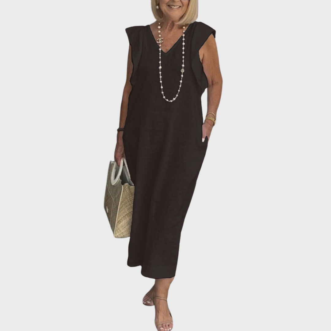 Women's sleeveless maxi dress with V-neck, delicate ruffle shoulders, and useful pockets, perfect for summer days.