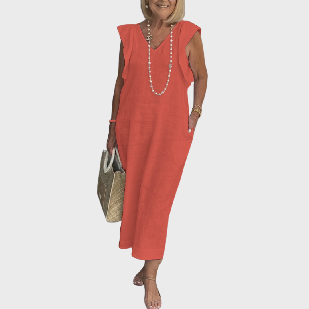 Resort wear women's flowy maxi dress, featuring a V-neck, ruffle shoulders, and practical pockets.