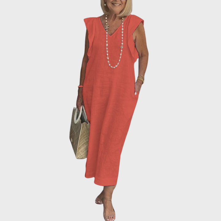 Resort wear women's flowy maxi dress, featuring a V-neck, ruffle shoulders, and practical pockets.