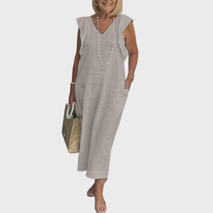 Elegant long women's dress: sleeveless, V-neck, ruffle shoulders, and side pockets, great for casual elegance.
