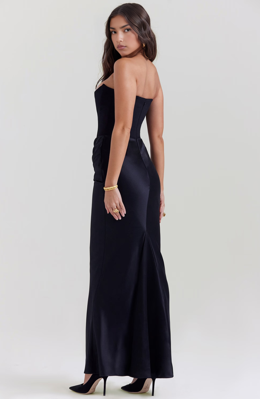 Black strapless wedding guest maxi dress. Elegant corset top, flowing long skirt.