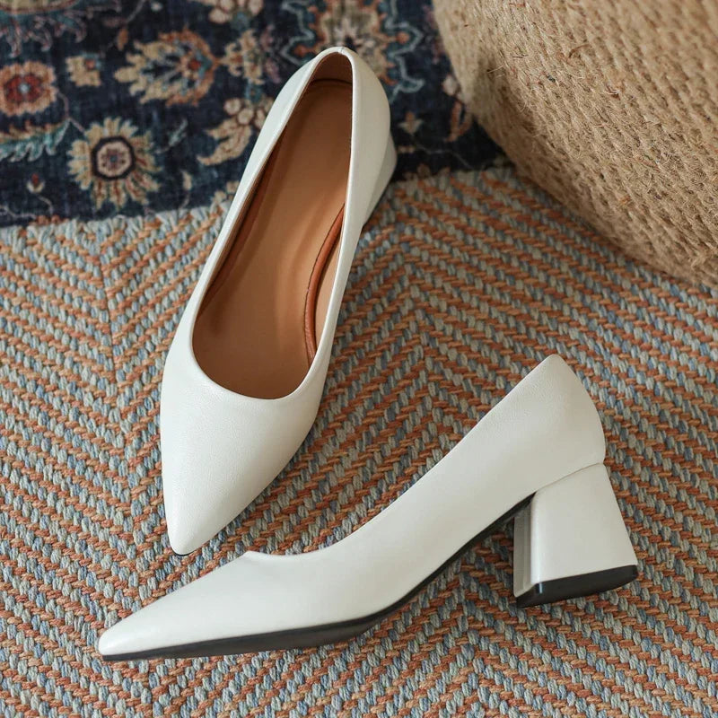 Stylish women's pointed toe block heels in a classic design, comfortable for office wear.