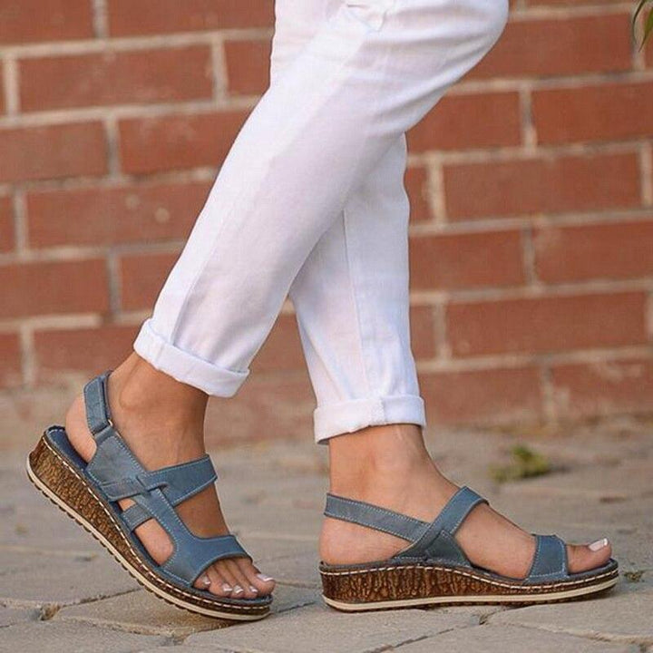 Stylish blue platform wedge sandals for women, ideal for warm weather casual and elegant outfits.