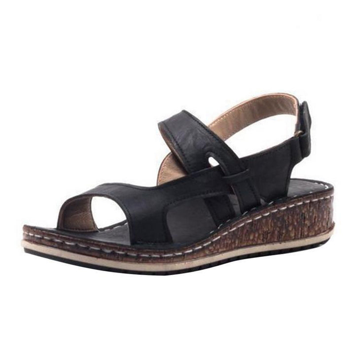 Chic women's wedge sandals in black, offering a comfortable and stylish option for summer events.