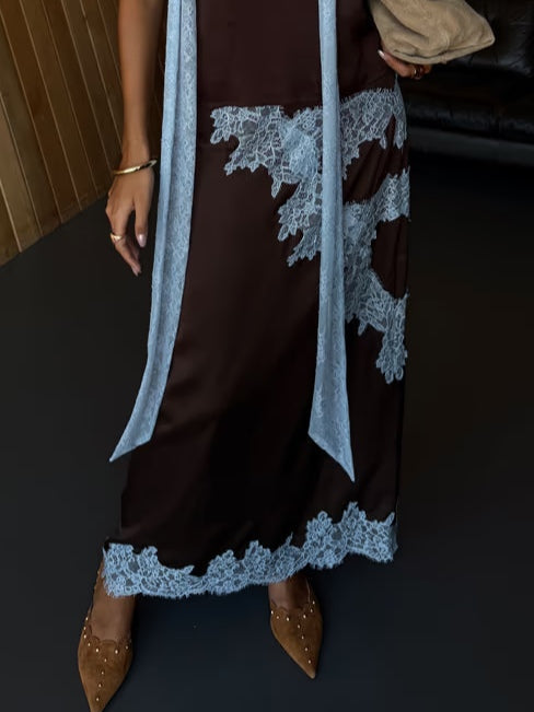 Elegant women's brown tie-dye halter maxi dress with side slit, a flowing summer vacation essential. (107 characters)